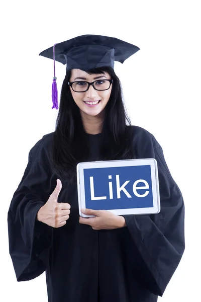 Attractive female graduate give like thumbs up on e-tablet — Stock Photo, Image