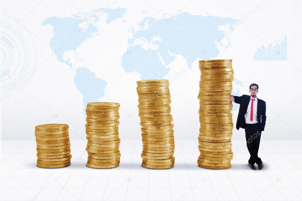Businessman and gold coins growth chart
