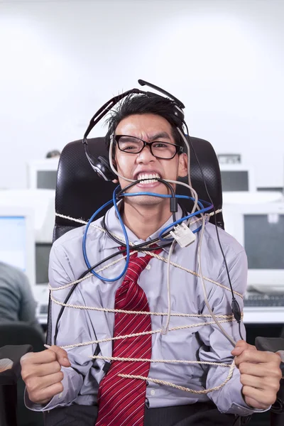 Stress businessman tied in rope at office — Stock Photo, Image