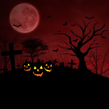mezar ve halloween balkabağı kırmızı dolunay altında
