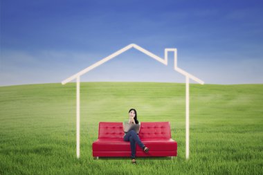 Pensive woman in dream house outdoor