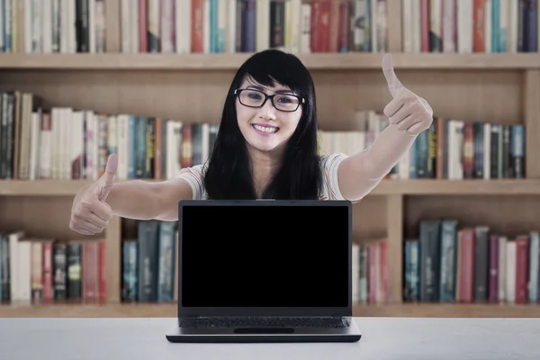 College student thumbs up in library — Stock Photo, Image