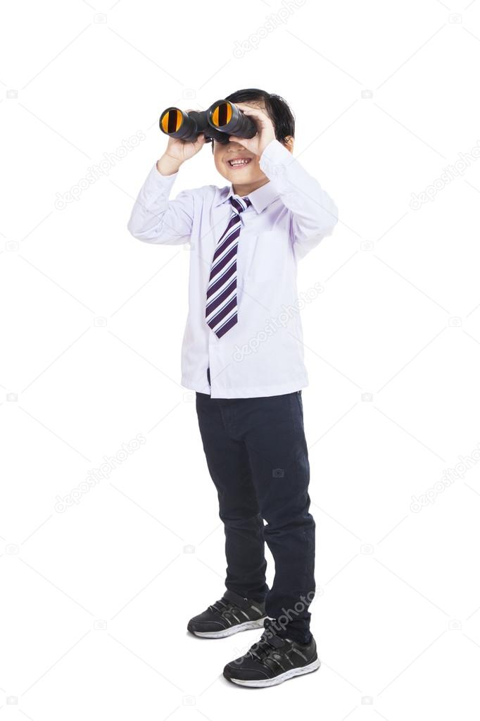 Business kid looking through binoculars - isolated