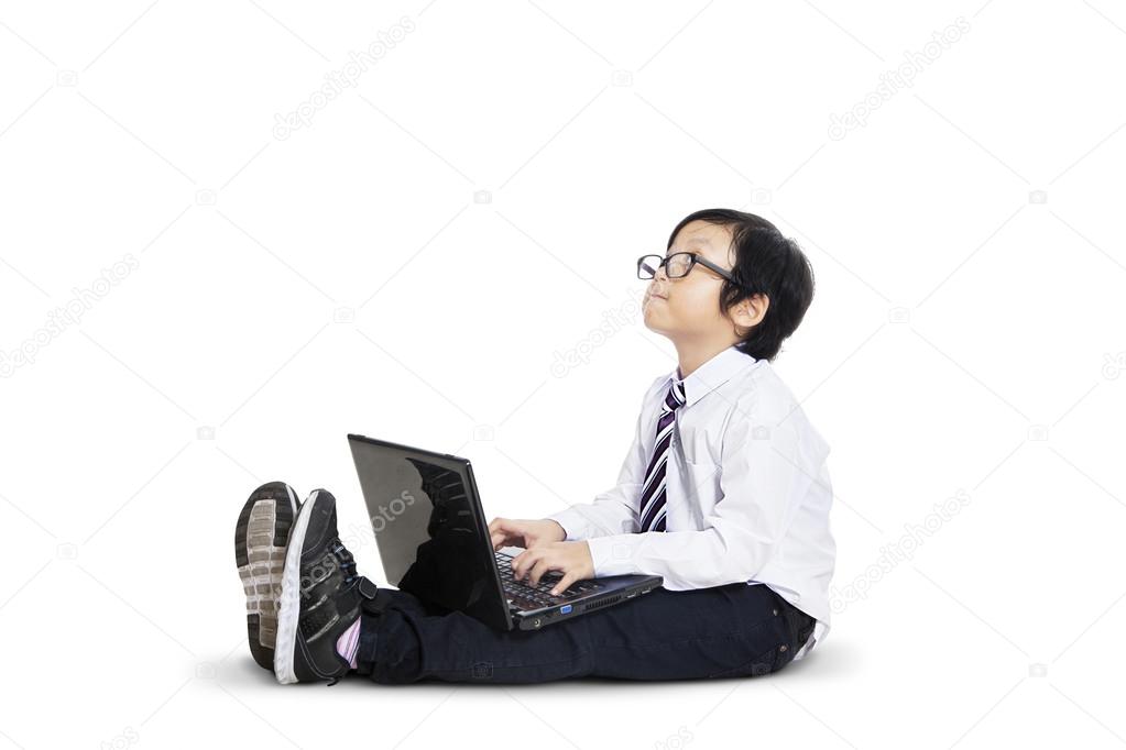 Cute little businessman using laptop - isolated