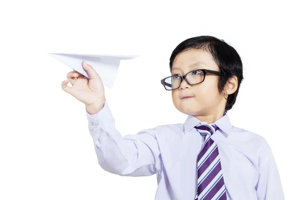 Confident business boy holding paper plane - isolated — Stock Photo, Image