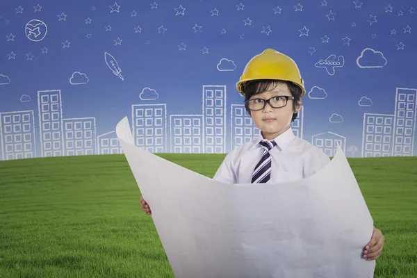 Cute architect boy holding plan outdoor — Stock Photo, Image