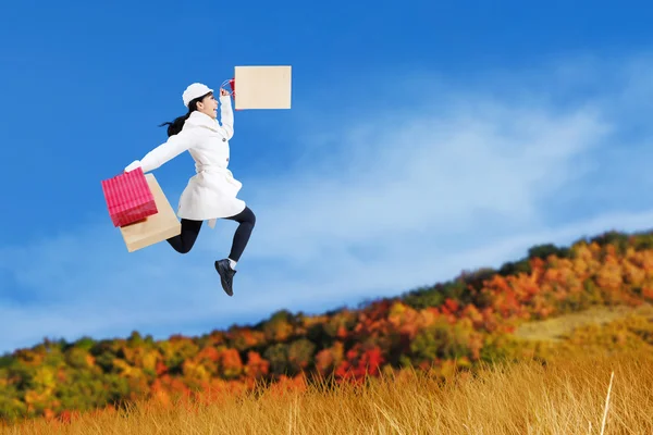 Autumn shopping woman jumping — Stock Photo, Image