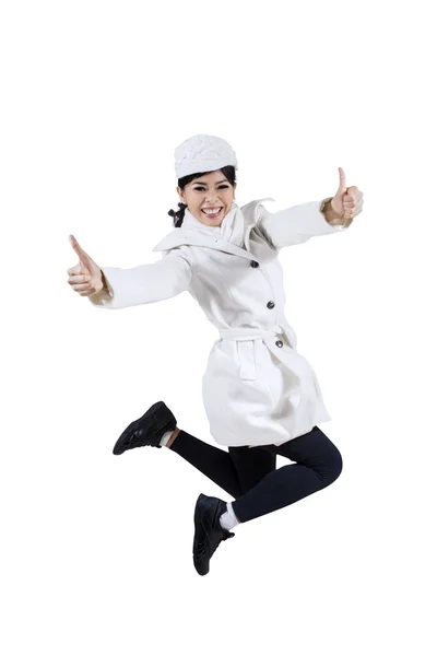 Young woman jumping showing OK sign — Stock Photo, Image