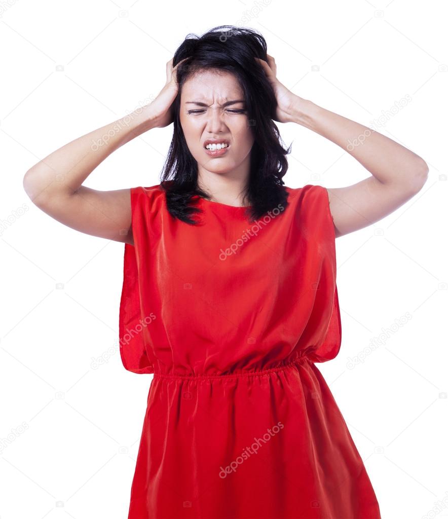 Stressed woman puts her hands on the head