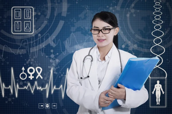 Beautiful female doctor holding folder on digital background — Stock Photo, Image