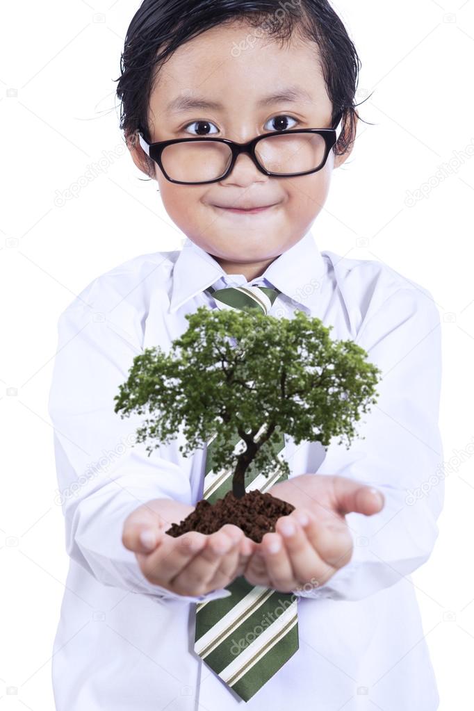 Little boy with plant in hands