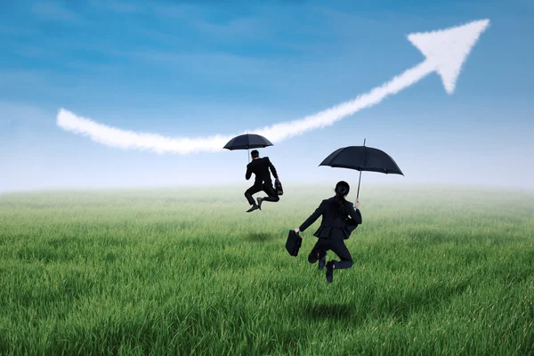 Happy insurance agent jumping with umbrella — Stock Photo, Image