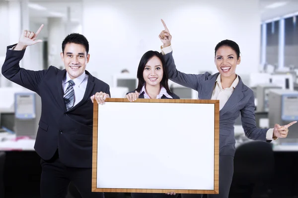 Business people holding empty board — Stock Photo, Image