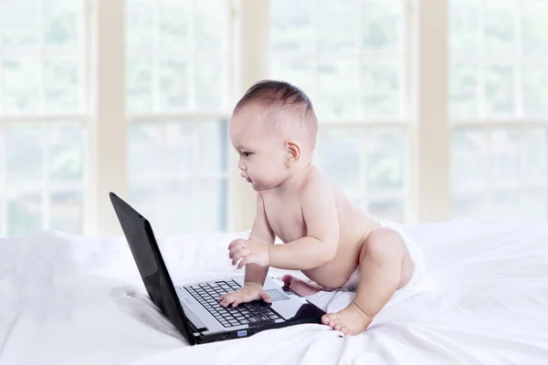 Baby playing with laptop — Stock Photo, Image