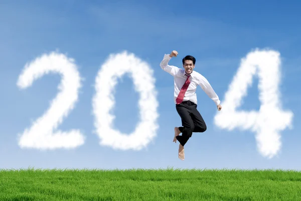 Zakenman springt met wolken van 2014 — Stockfoto