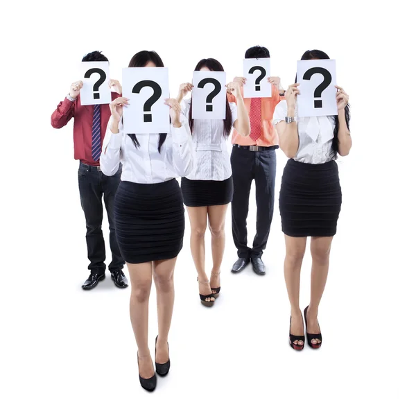 Business team hiding behind question mark symbol — Stock Photo, Image