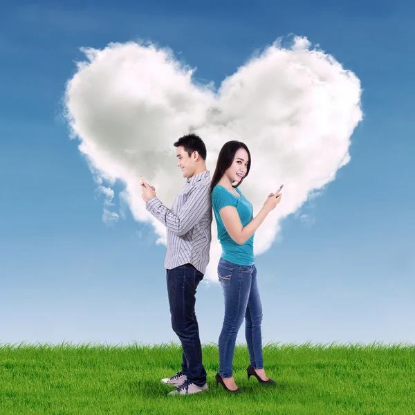 Cep telefonu kullanan genç çift.