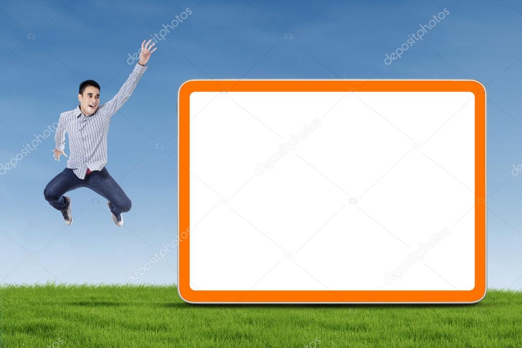 Man jumping with blank board