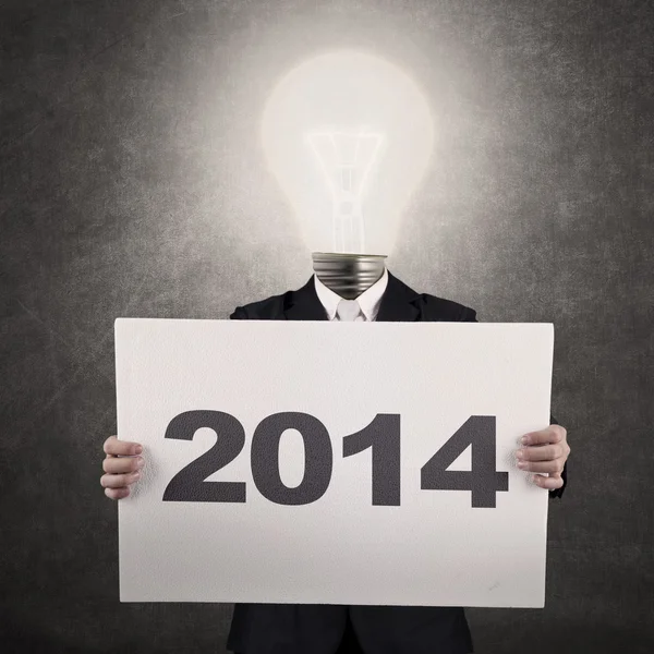 Businessman with lamp-head showing year 2014 — Stockfoto