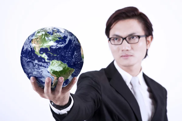 Businessman giving globe - isolated — Stock Photo, Image