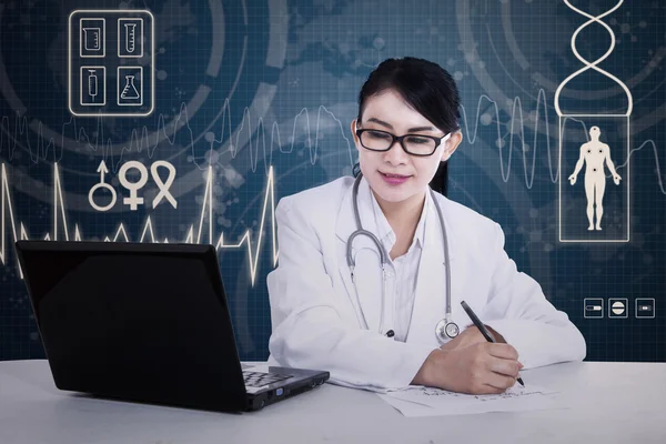 Asian doctor is writing prescription — Stock Photo, Image