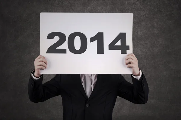 Empresário Escondendo formulário O ano de 2014 — Fotografia de Stock