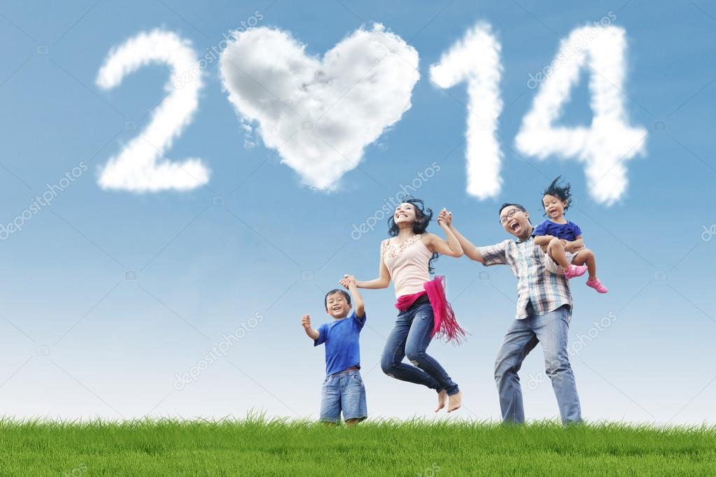 Asian family having fun under cloud of new year 2014