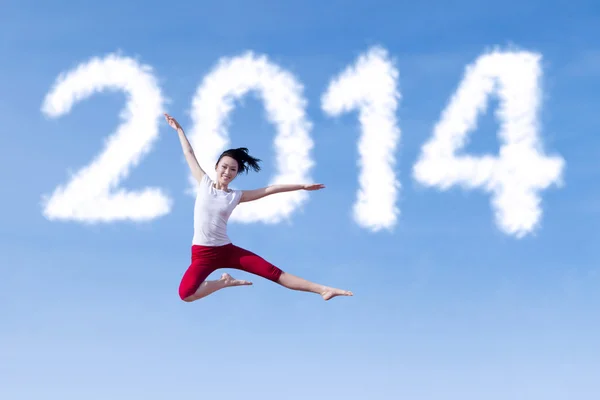 Excited woman dancing with new year 2014 — Stock Photo, Image