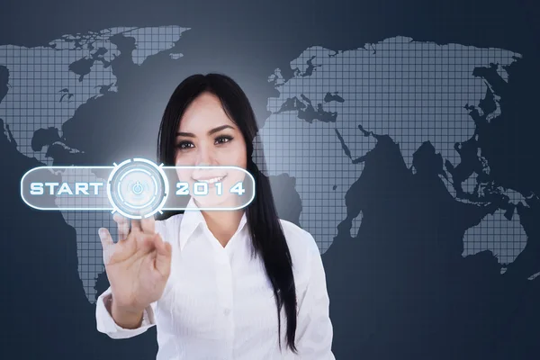 Young businesswoman touching a button — Stock Photo, Image