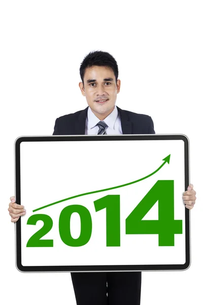 Joven empresario mostrando el nuevo año 2014 —  Fotos de Stock