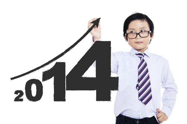 Uma criança escrevendo o ano novo 2014 — Fotografia de Stock