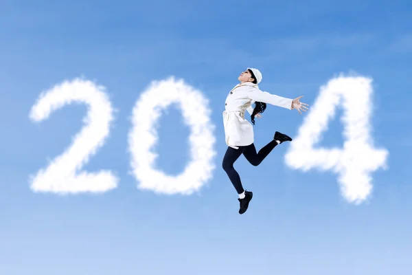 Woman jumping with numbers of 2014 — Stock Photo, Image