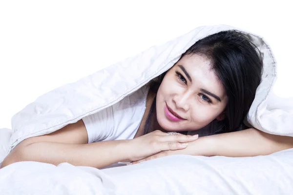 Mooie vrouw onder deken in bed — Stockfoto