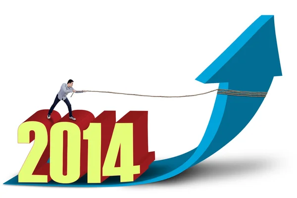 Man pulls 2014 on arrow sign — Stock Photo, Image