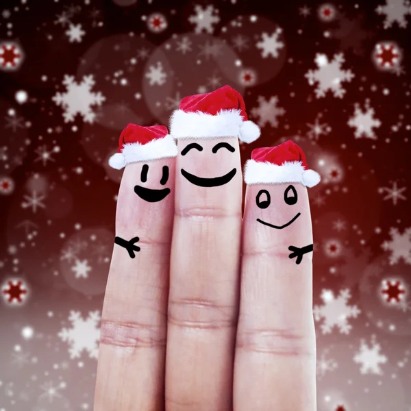 Glückliche Finger-Smileys in Weihnachtsmützen — Stockfoto