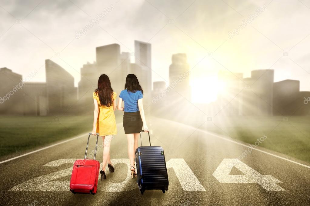 Two woman walking on the road