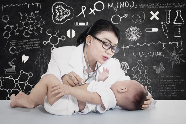 Atractiva mujer médico chequeo bebé en el laboratorio — Foto de Stock