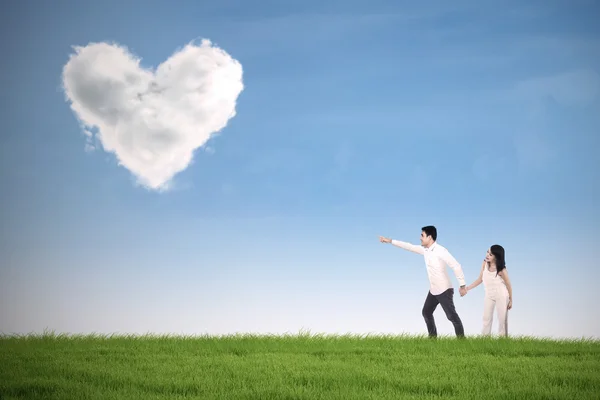 Romantic couple pointing at heart — Stock Photo, Image