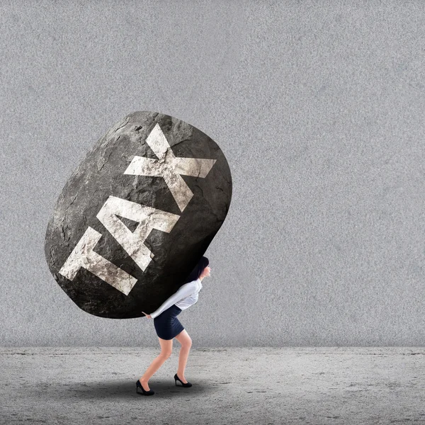 Businesswoman carrying a big rock of TAX — Stock Photo, Image