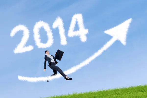Businesswoman with 2014 symbol of new year — Stock Photo, Image