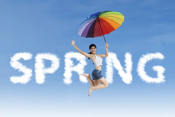 Woman jumps in the spring word — Stock Photo, Image