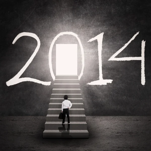 Boy walking into the new future door — Stock Photo, Image