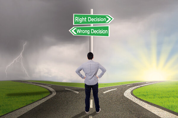 Businessman with a sign of right vs wrong decision