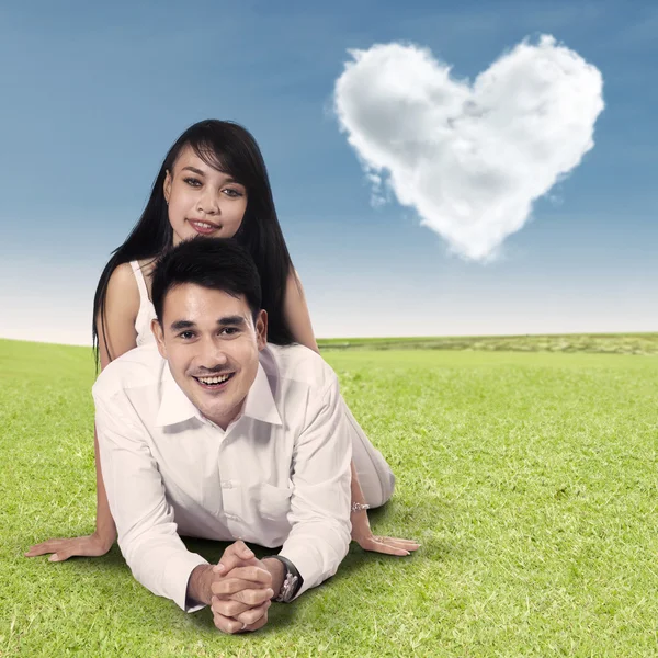 Happy couple with clouds shaped of heart — Stock Photo, Image
