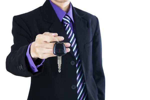Businessman offering a car key Royalty Free Stock Photos