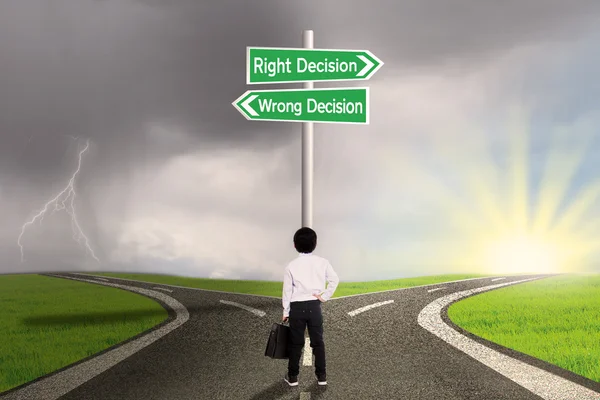 Criança de negócios com um sinal de decisão certa vs errada — Fotografia de Stock