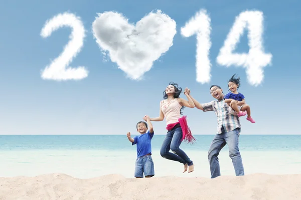 La famiglia felice festeggia l'anno nuovo il 2014 a spiaggia — Foto Stock