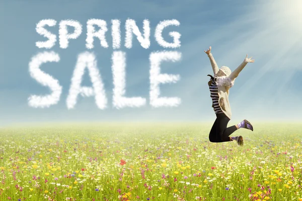 Woman jumping with text of spring sale — Stock Photo, Image