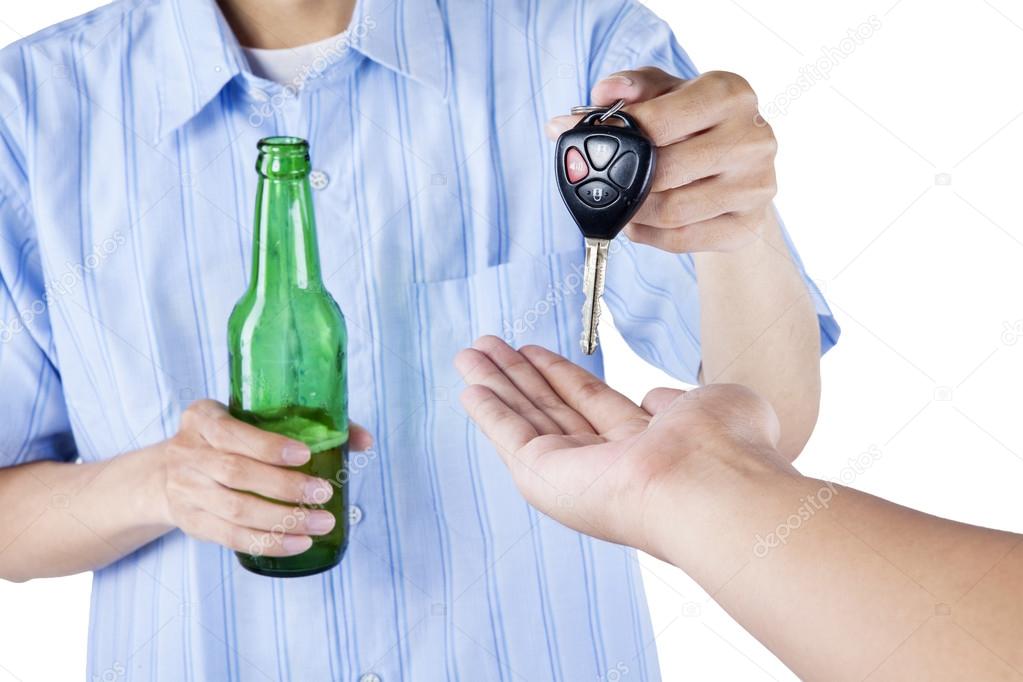 A drunk driver giving a car key to someone