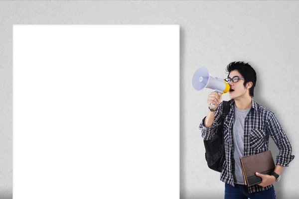 Guy with megaphone and blank board — Stock Photo, Image